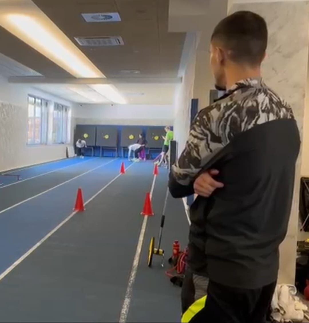 Kajetan coaching athletes on the track
